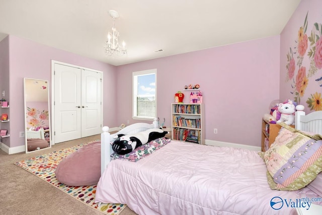 bedroom with a closet, baseboards, a chandelier, and carpet flooring