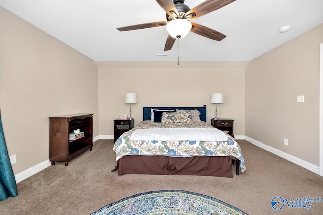 carpeted bedroom with ceiling fan and baseboards