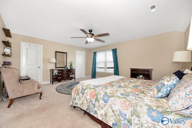 bedroom featuring a ceiling fan, visible vents, light carpet, and baseboards