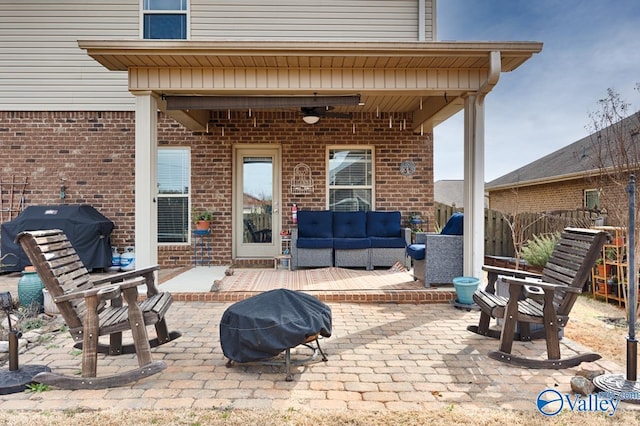 view of patio with fence, grilling area, a ceiling fan, and an outdoor living space