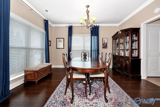 dining room with an inviting chandelier, wood finished floors, and crown molding