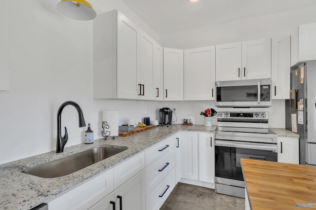 kitchen with white cabinets, sink, and stainless steel appliances