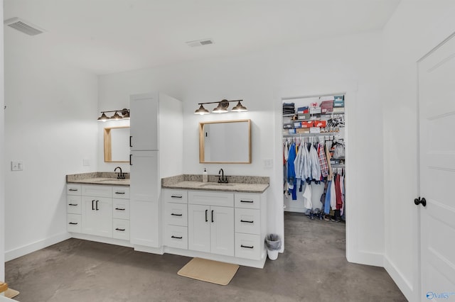 bathroom featuring vanity and concrete floors