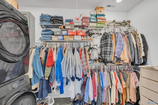 spacious closet featuring stacked washer / drying machine