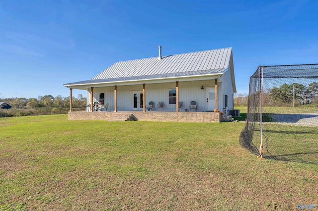 rear view of house with french doors, a yard, and central AC unit