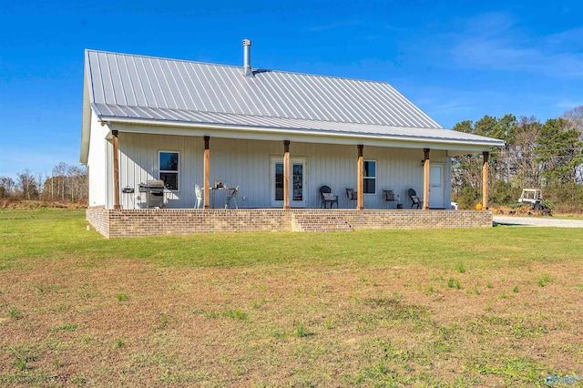 back of house with a lawn