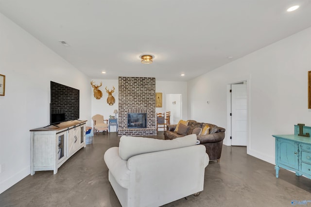 living room with a fireplace and concrete floors