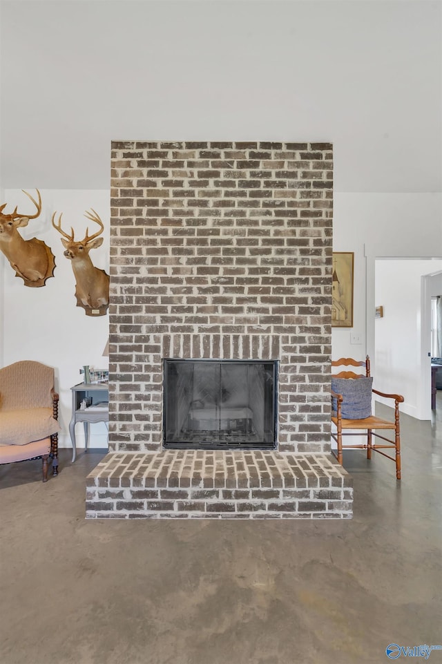 interior details featuring a fireplace and concrete floors