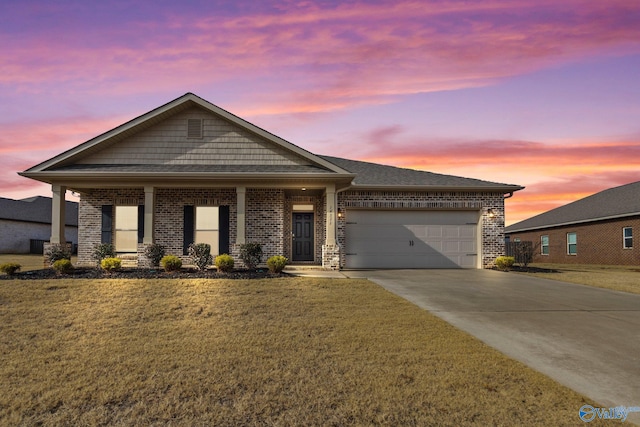 view of front of house featuring a garage and a yard