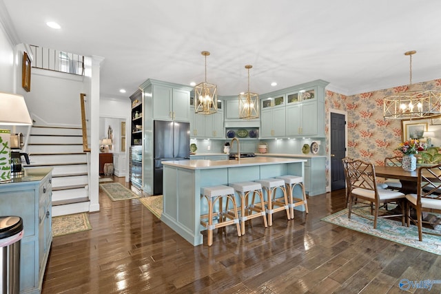 1176 N Lake Forest Dr, Southside, AL 35907 - kitchen featuring freestanding refrigerator, a chandelier, wallpapered walls, light countertops, and an island with sink