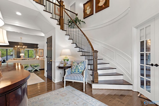 1176 N Lake Forest Dr, Southside, AL 35907 - foyer featuring a wainscoted wall, wood finished floors, a decorative wall, a chandelier, and stairs