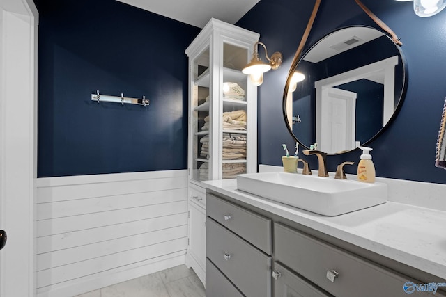 1176 N Lake Forest Dr, Southside, AL 35907 - bathroom with visible vents, marble finish floor, vanity, and wainscoting