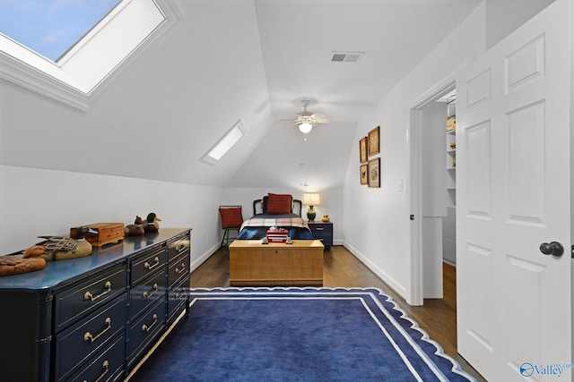 1176 N Lake Forest Dr, Southside, AL 35907 - bedroom with a ceiling fan, vaulted ceiling with skylight, baseboards, dark wood-style flooring, and visible vents
