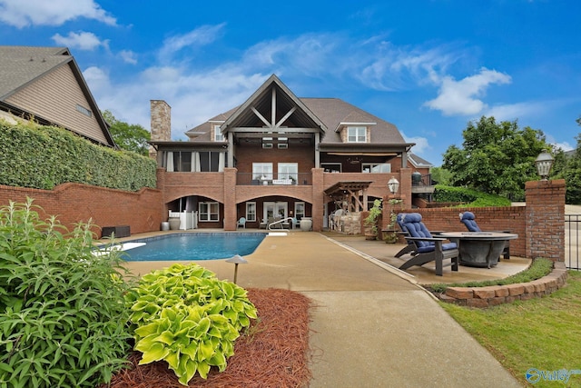 1176 N Lake Forest Dr, Southside, AL 35907 - rear view of house featuring a fenced in pool, a balcony, a patio, a fire pit, and brick siding