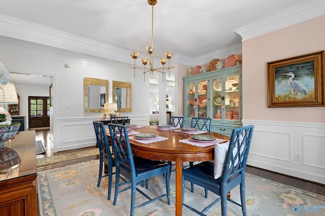1176 N Lake Forest Dr, Southside, AL 35907 - dining area with a wainscoted wall, ornamental molding, a decorative wall, a chandelier, and light wood-style flooring