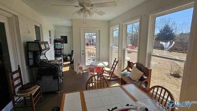 sunroom featuring ceiling fan