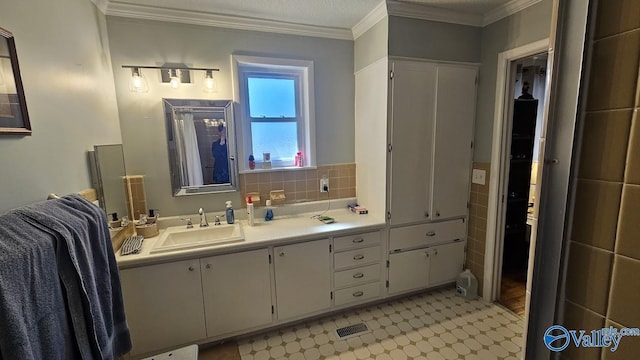 full bathroom with tile patterned floors, visible vents, ornamental molding, and vanity