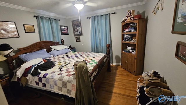 bedroom with a ceiling fan, crown molding, and wood finished floors