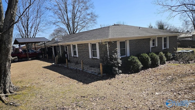 view of property exterior featuring brick siding and a shingled roof