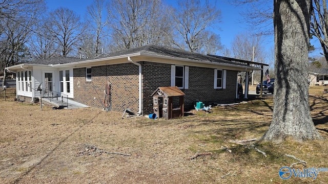 view of side of home featuring brick siding