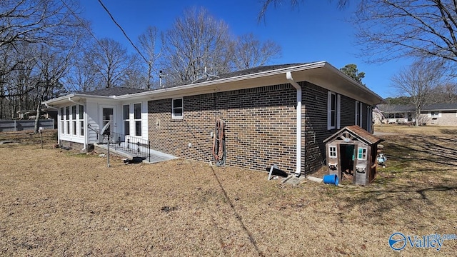 view of side of property featuring brick siding