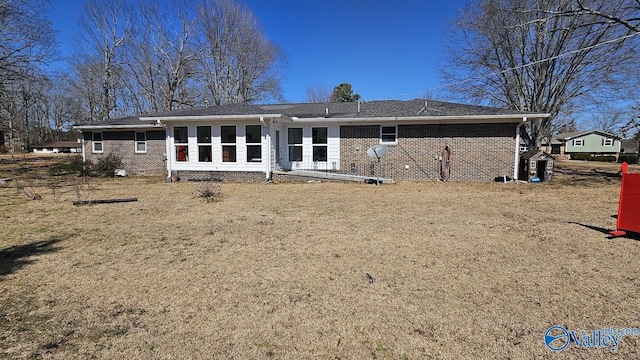 rear view of house featuring crawl space and brick siding