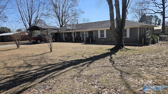 view of front of property with driveway and brick siding