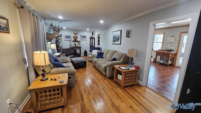 living room featuring ornamental molding, recessed lighting, light wood-style flooring, and baseboards