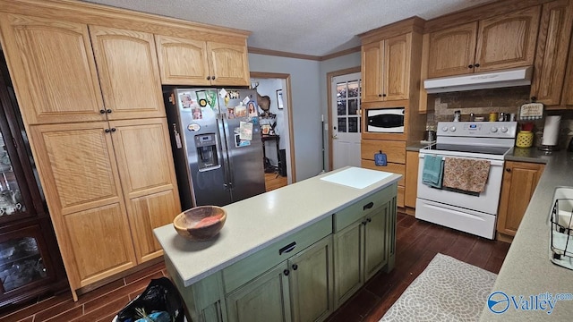 kitchen featuring white appliances, dark wood-style flooring, crown molding, under cabinet range hood, and green cabinetry