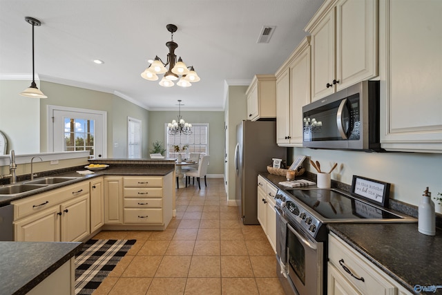 kitchen with appliances with stainless steel finishes, sink, hanging light fixtures, and a notable chandelier