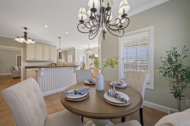 dining area with an inviting chandelier, light tile patterned floors, crown molding, and sink