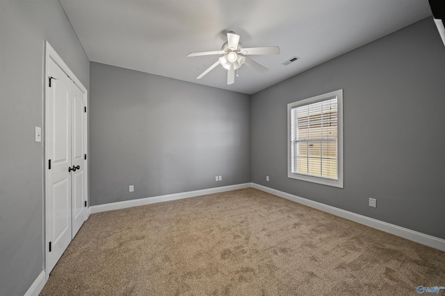 spare room with ceiling fan and carpet flooring