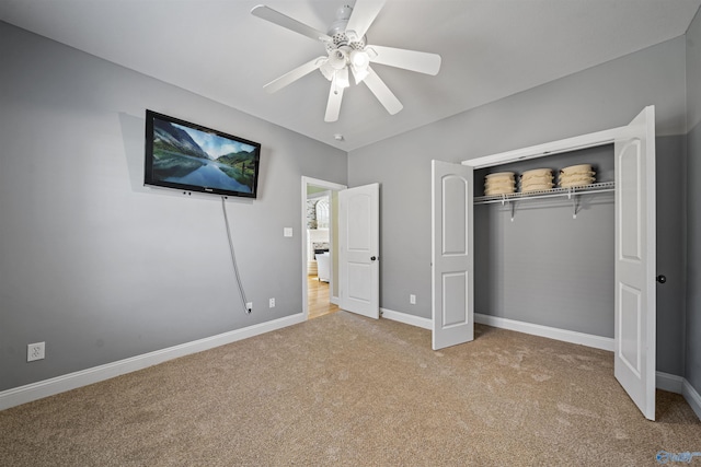 unfurnished bedroom with ceiling fan, light carpet, and a closet