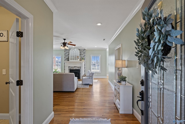 hallway with hardwood / wood-style floors and ornamental molding