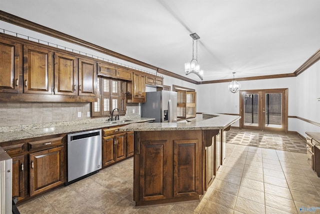 kitchen featuring a kitchen island, pendant lighting, a chandelier, appliances with stainless steel finishes, and decorative backsplash