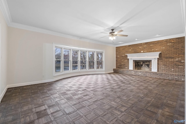 unfurnished living room featuring a brick fireplace, baseboards, ceiling fan, ornamental molding, and brick wall
