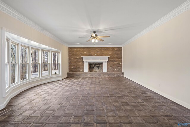 unfurnished living room featuring baseboards, ornamental molding, a ceiling fan, and a brick fireplace