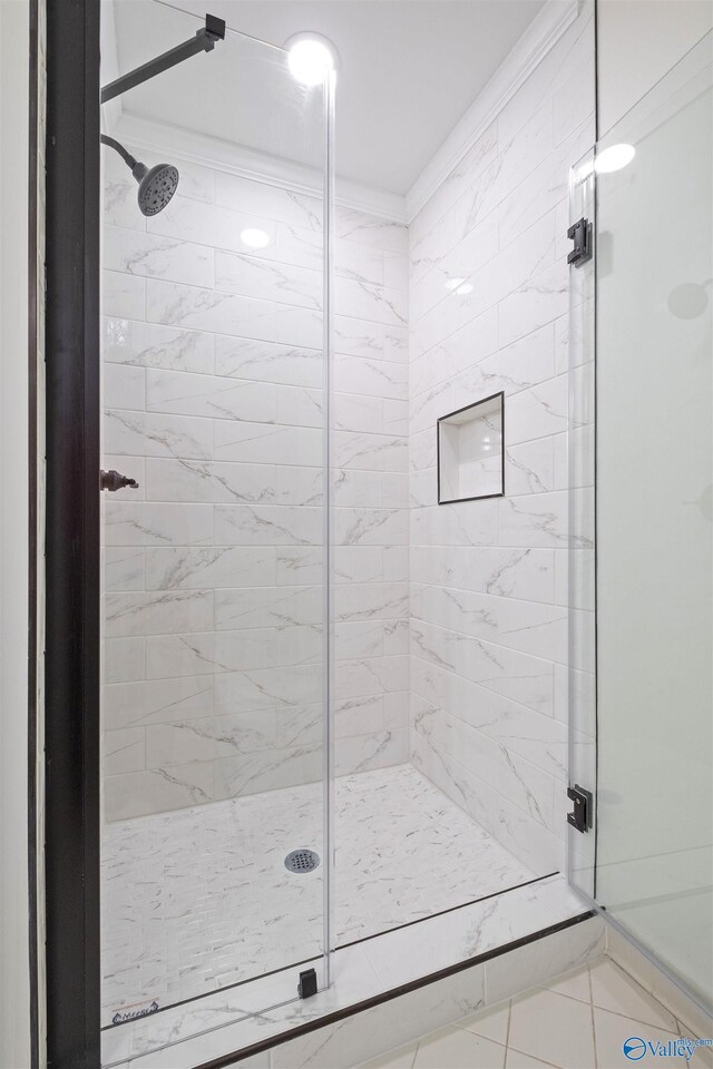 bathroom featuring a stall shower and crown molding