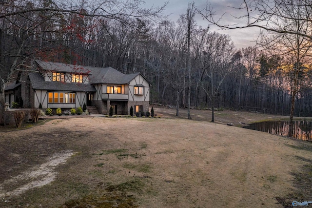 view of front of property with a view of trees
