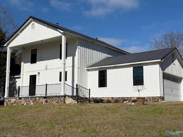 view of side of home featuring a yard and a garage