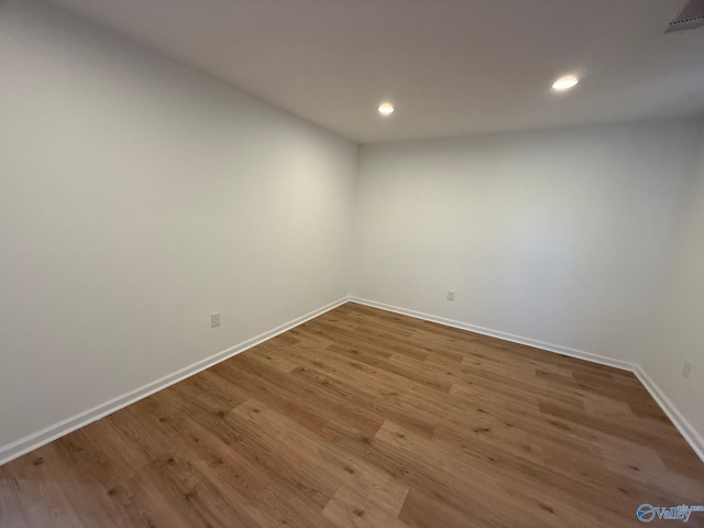 unfurnished room featuring hardwood / wood-style flooring