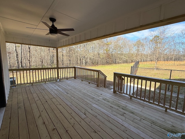 wooden terrace featuring ceiling fan and a yard