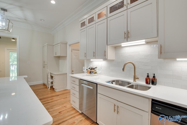 kitchen with crown molding, a sink, decorative backsplash, and dishwasher