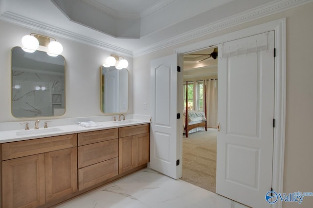 bathroom featuring a ceiling fan, ornamental molding, a sink, and marble finish floor
