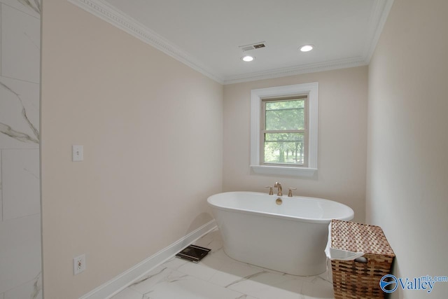bathroom featuring a freestanding tub, baseboards, marble finish floor, ornamental molding, and recessed lighting