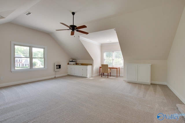 bonus room with visible vents, heating unit, light carpet, a ceiling fan, and vaulted ceiling