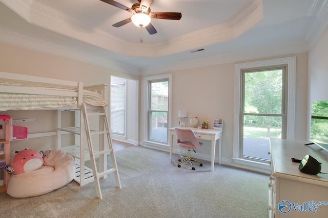 bedroom with carpet floors, ornamental molding, a tray ceiling, and visible vents