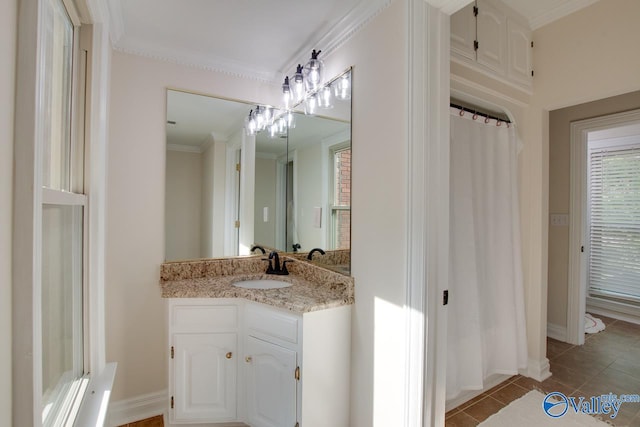 bathroom featuring vanity, baseboards, crown molding, and tile patterned floors