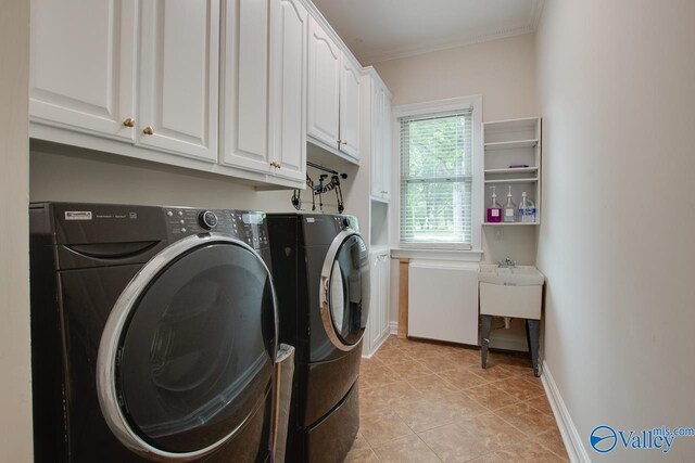 laundry room featuring separate washer and dryer, ornamental molding, baseboards, and cabinet space