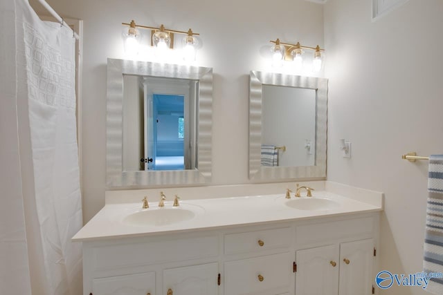 full bath with double vanity and a sink